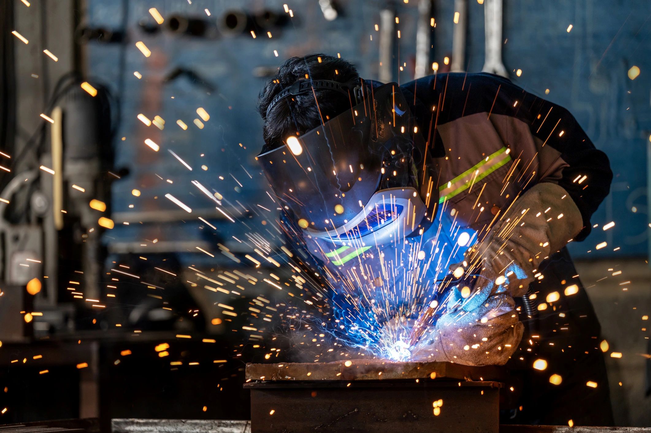 Welder working with sparks in a workshop